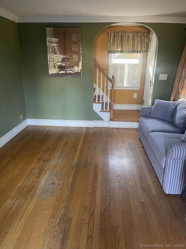 living room featuring hardwood / wood-style floors and crown molding