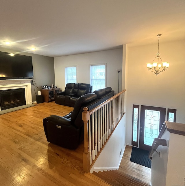 living room with wood-type flooring and a notable chandelier