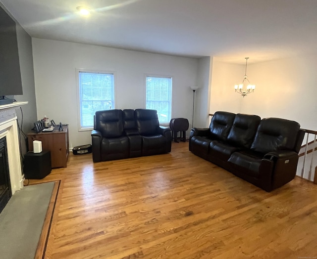 living room with light hardwood / wood-style flooring and an inviting chandelier