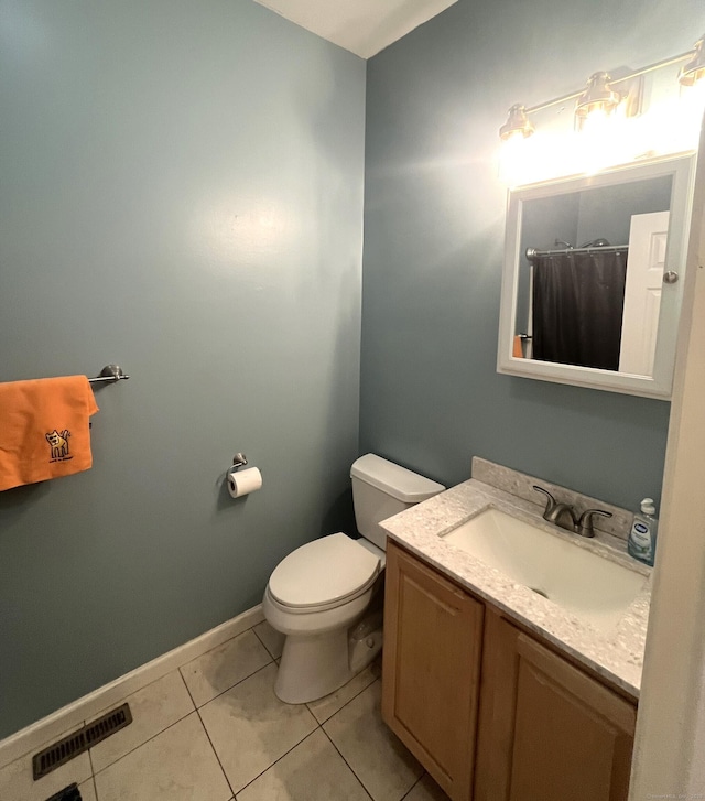 bathroom featuring tile patterned floors, a shower with curtain, vanity, and toilet