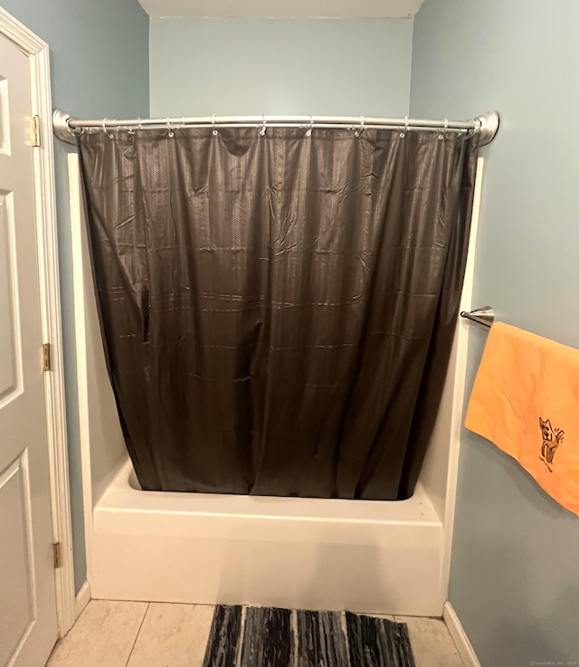 bathroom featuring tile patterned floors and shower / bath combo with shower curtain