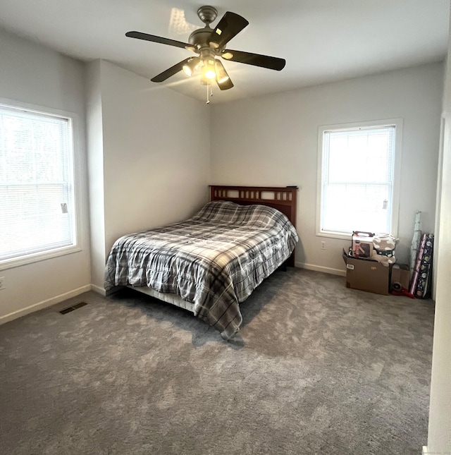 bedroom featuring ceiling fan and dark carpet