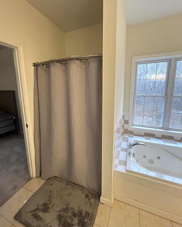 bathroom with tile patterned flooring and a washtub