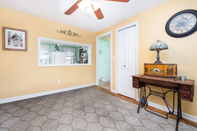 interior space featuring ceiling fan, hardwood / wood-style flooring, a closet, and white fridge