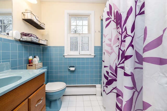 bathroom with toilet, vanity, tile patterned flooring, tile walls, and a baseboard heating unit