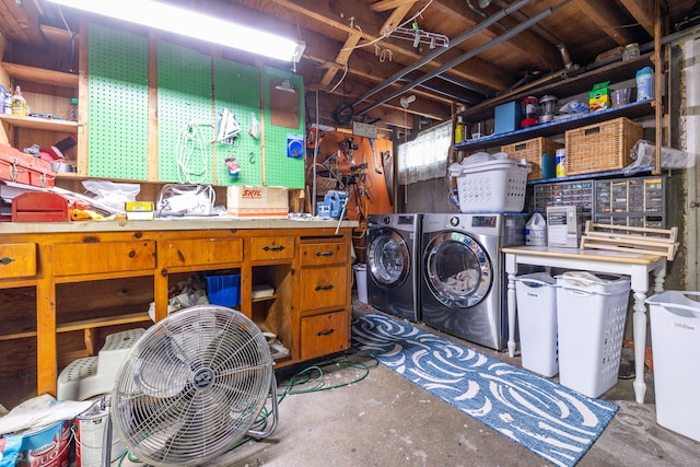 laundry area featuring washing machine and clothes dryer and a workshop area