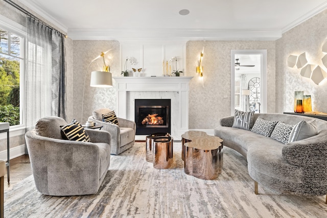 interior space featuring ornamental molding, a high end fireplace, baseboards, and wood finished floors