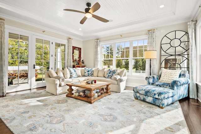 sunroom featuring a ceiling fan, a tray ceiling, wooden ceiling, and french doors