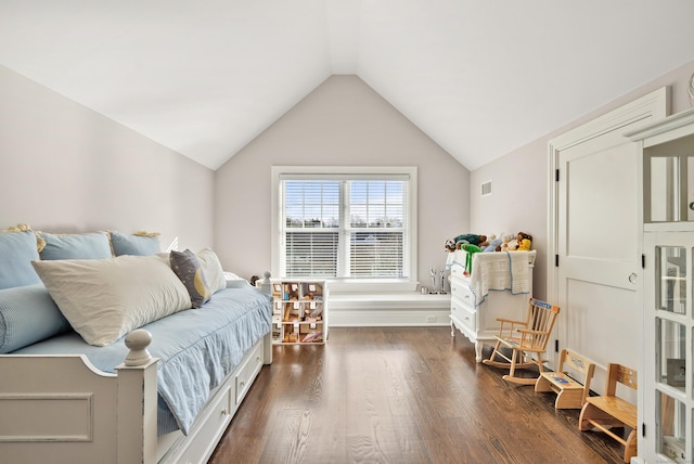 bedroom featuring lofted ceiling, dark wood-style floors, and visible vents