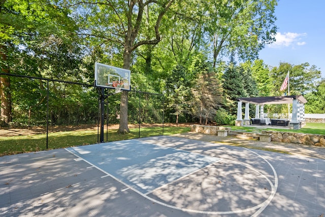 view of sport court featuring basketball hoop and a gazebo