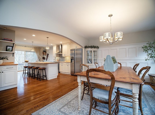 dining area featuring a notable chandelier and dark hardwood / wood-style flooring