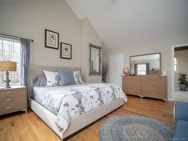 bedroom featuring light hardwood / wood-style floors and lofted ceiling