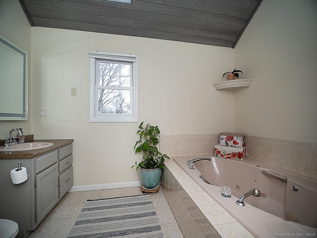 bathroom with tile patterned flooring, vanity, a relaxing tiled tub, and vaulted ceiling