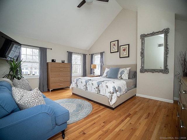 bedroom with multiple windows, light wood-type flooring, high vaulted ceiling, and ceiling fan