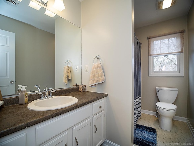 bathroom featuring tile patterned floors, vanity, and toilet