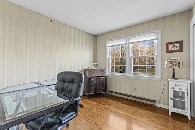 office space featuring baseboard heating and hardwood / wood-style flooring