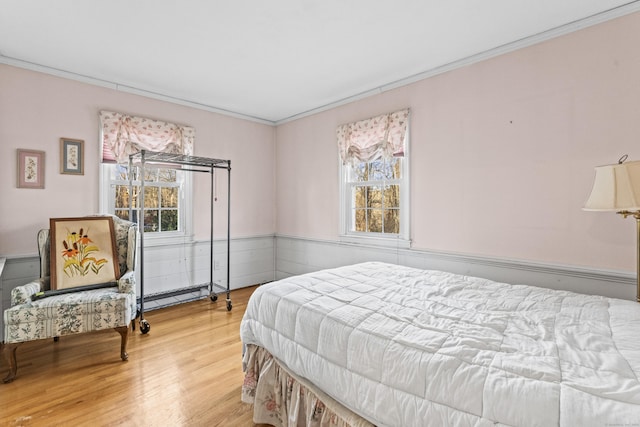 bedroom with ornamental molding and hardwood / wood-style flooring