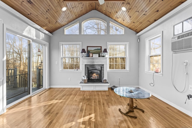 interior space with light wood-type flooring, wooden ceiling, and plenty of natural light