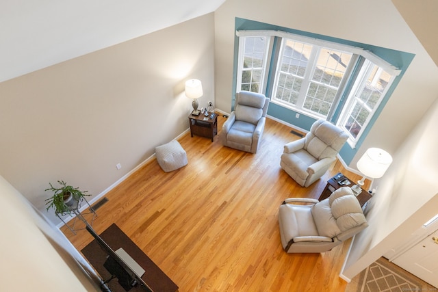 sitting room with light hardwood / wood-style flooring and vaulted ceiling