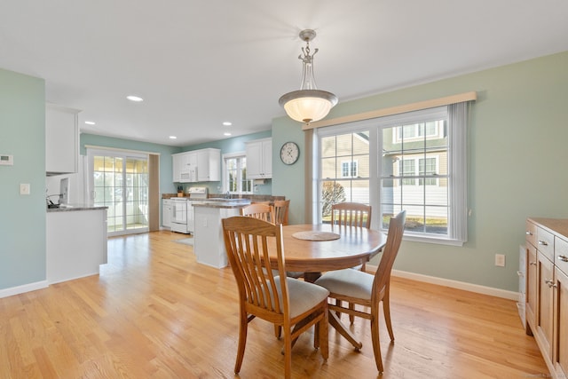 dining space featuring light hardwood / wood-style floors and sink