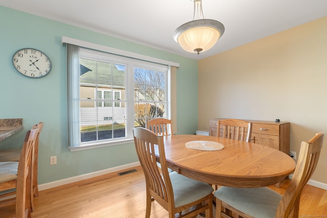 dining space with light wood-type flooring