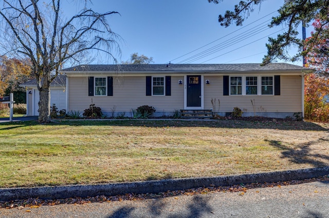 ranch-style home with a garage and a front lawn