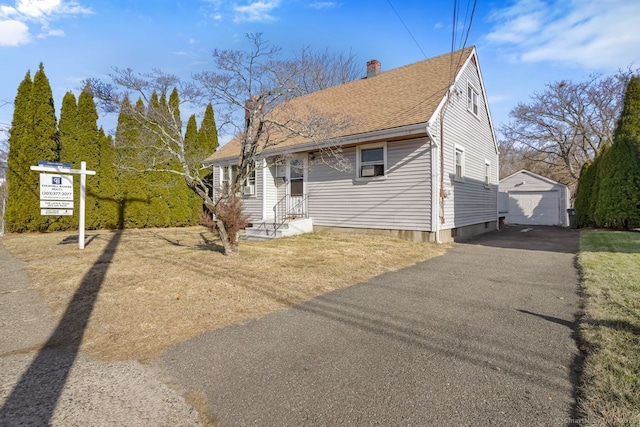 view of front of house with a garage and an outdoor structure