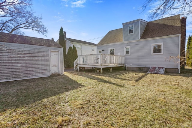 back of house with a lawn and a wooden deck