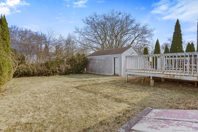 view of yard featuring a deck and a storage unit