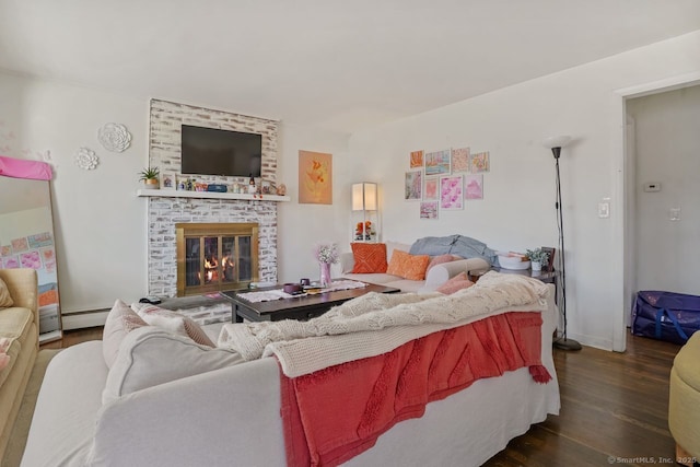 living room with a fireplace, dark wood-type flooring, and a baseboard heating unit