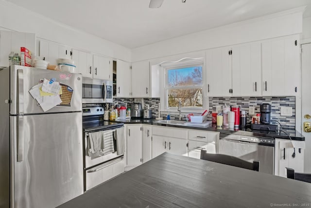 kitchen featuring white cabinets, decorative backsplash, sink, and stainless steel appliances