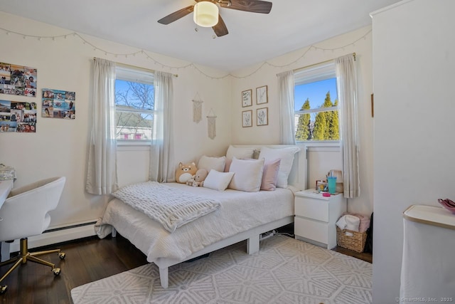 bedroom featuring light hardwood / wood-style flooring, ceiling fan, and a baseboard heating unit