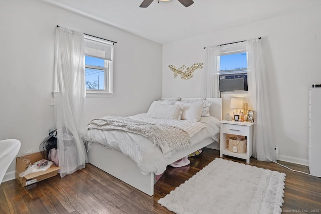 bedroom with ceiling fan and dark hardwood / wood-style flooring