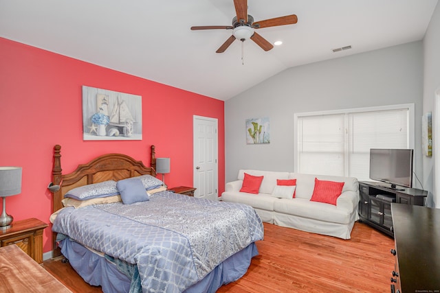 bedroom featuring wood-type flooring, vaulted ceiling, and ceiling fan