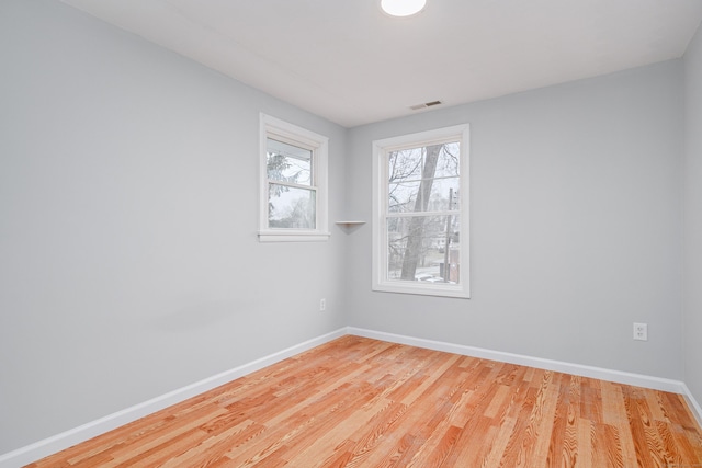 spare room featuring light hardwood / wood-style floors