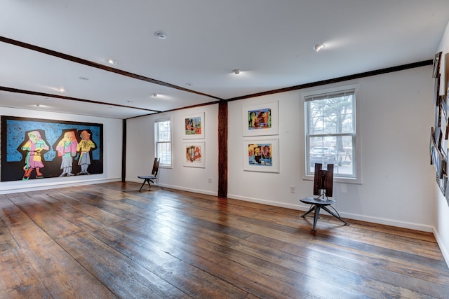 interior space with ornamental molding and dark hardwood / wood-style flooring