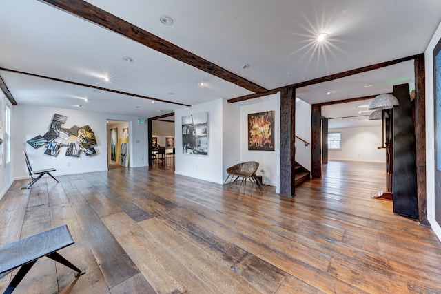 living room with dark hardwood / wood-style floors and beam ceiling