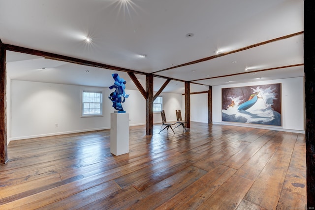 interior space with lofted ceiling with beams and wood-type flooring