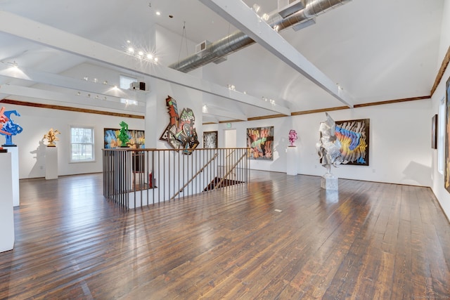 interior space with dark wood-type flooring and high vaulted ceiling