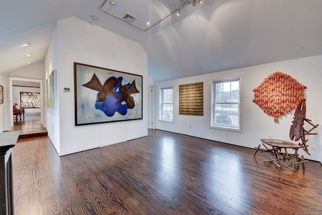 interior space featuring lofted ceiling and dark hardwood / wood-style flooring