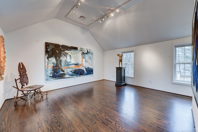 additional living space with dark hardwood / wood-style floors and vaulted ceiling