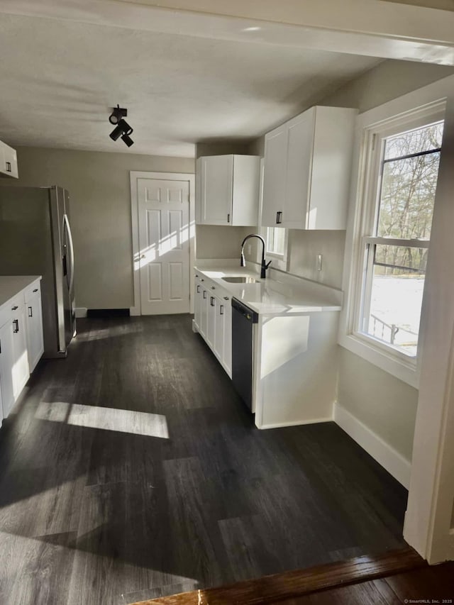 kitchen featuring sink, stainless steel appliances, dark hardwood / wood-style flooring, and white cabinetry