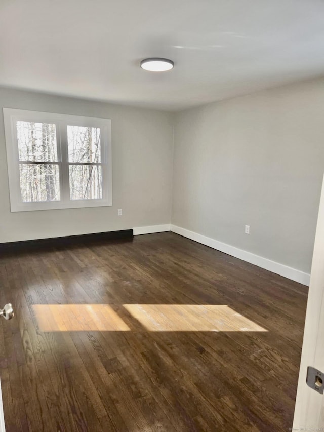 spare room with dark hardwood / wood-style flooring