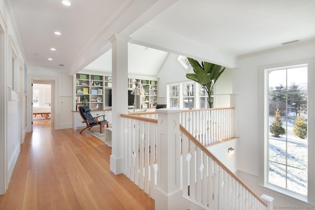 hall with crown molding and light hardwood / wood-style flooring