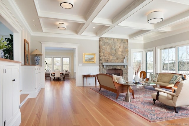145 Taconic Rd, Salisbury, CT 06068 - living area with light wood-style flooring, coffered ceiling, beamed ceiling, a fireplace, and crown molding