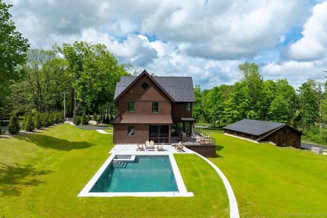 145 Taconic Rd, Salisbury, CT 06068 - back of property featuring a lawn, an outdoor pool, and a patio area