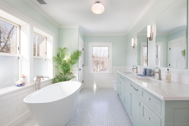 145 Taconic Rd, Salisbury, CT 06068 - full bathroom featuring tile walls, wainscoting, double vanity, a soaking tub, and tile patterned floors