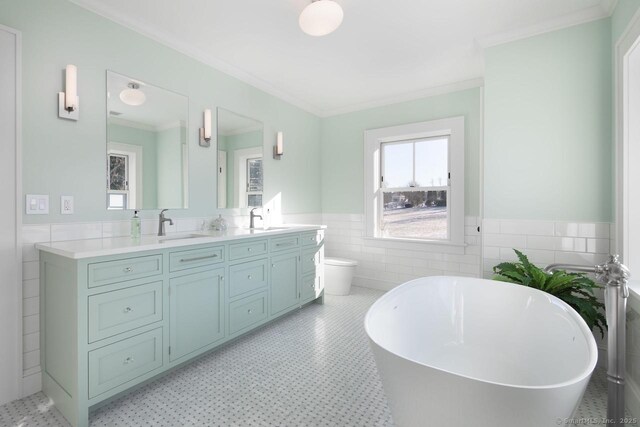 145 Taconic Rd, Salisbury, CT 06068 - full bathroom with tile walls, double vanity, a soaking tub, a wainscoted wall, and toilet
