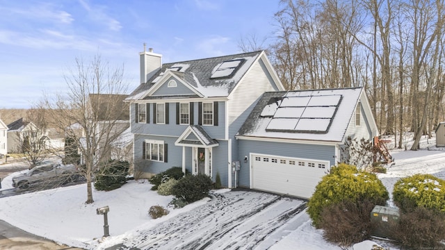 view of front of home featuring a garage and solar panels