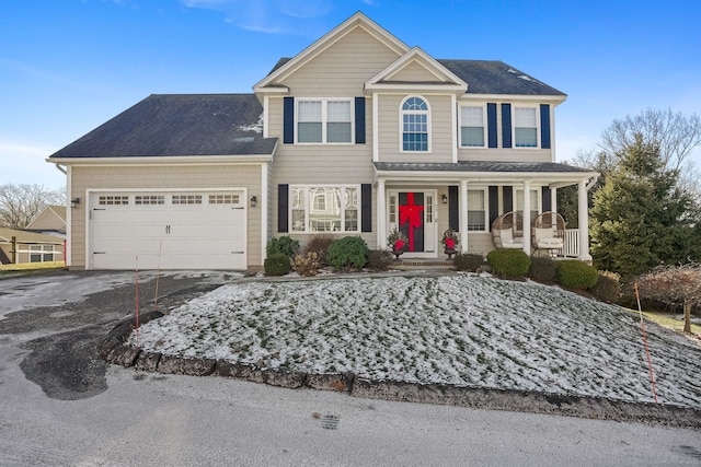 view of front of home with a porch and a garage